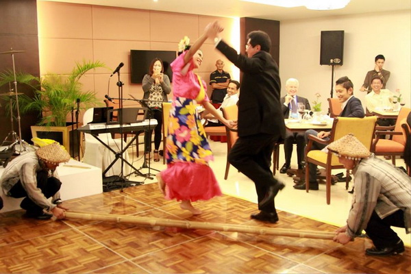 Vice-Minister of Energy and Mines Guillermo Shinno Huamani of  Peru trying the Tinikling Dance during the Welcome Dinner  for the Mining Task Force Meeting hosted by the MGB-DENR.